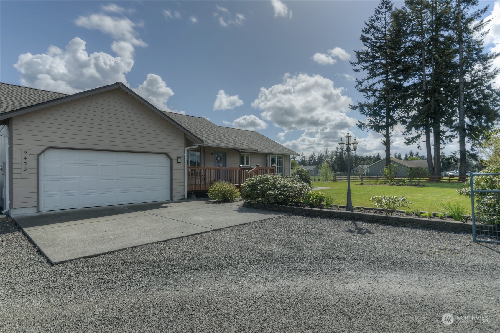 9425 180th Way Southwest Rochester, WA 98579 - Photo 4 of 37 a view of a house with a backyard and a tree