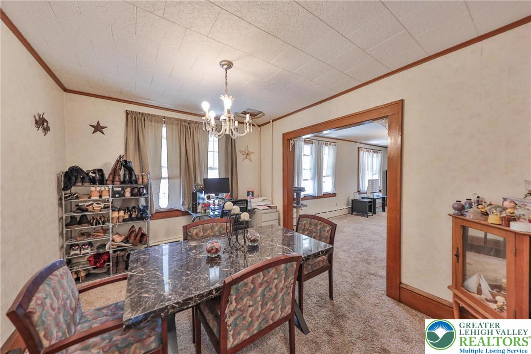 417 3rd Street Lehighton, PA 18235 - Photo 17 of 39 This formal dining space offers ample room for gatherings, featuring a classic chandelier and wood trim accents.
