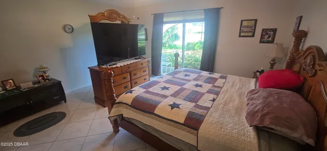 a bedroom with a bed and flat screen tv