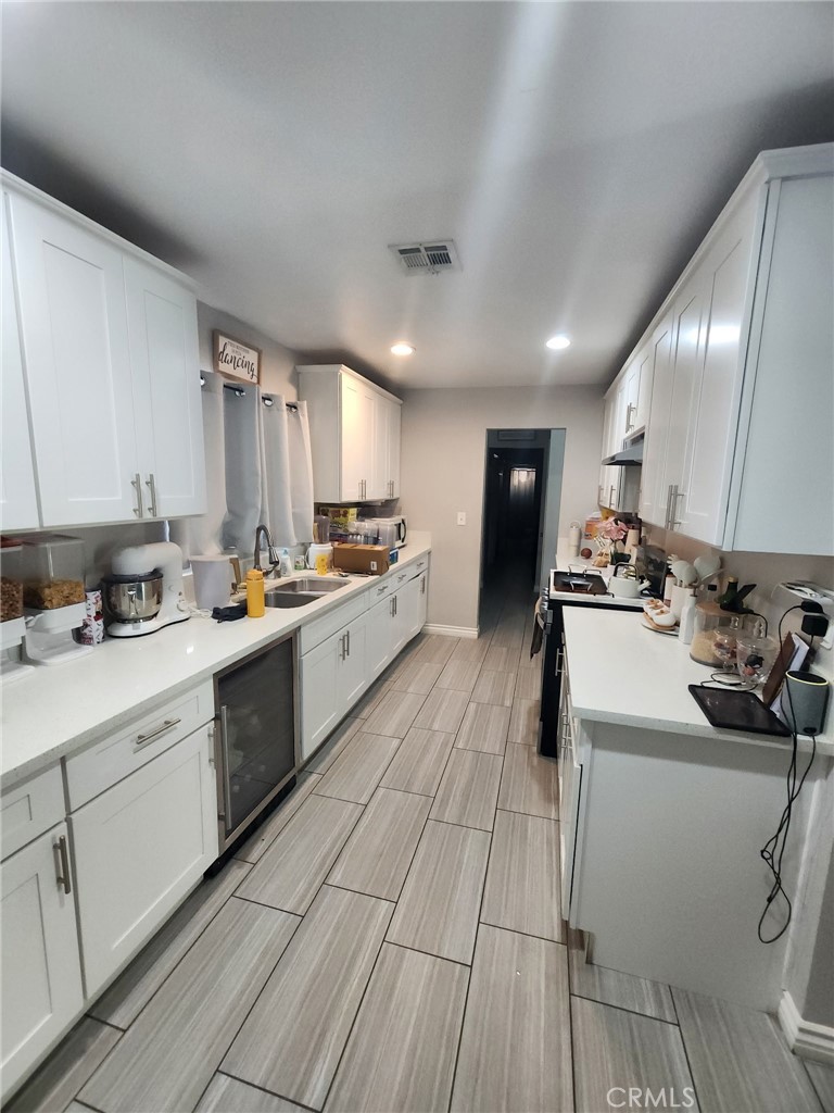 3316 Joel Drive Riverside, CA 92509 - Photo 3 of 6 a kitchen with cabinets a sink and appliances