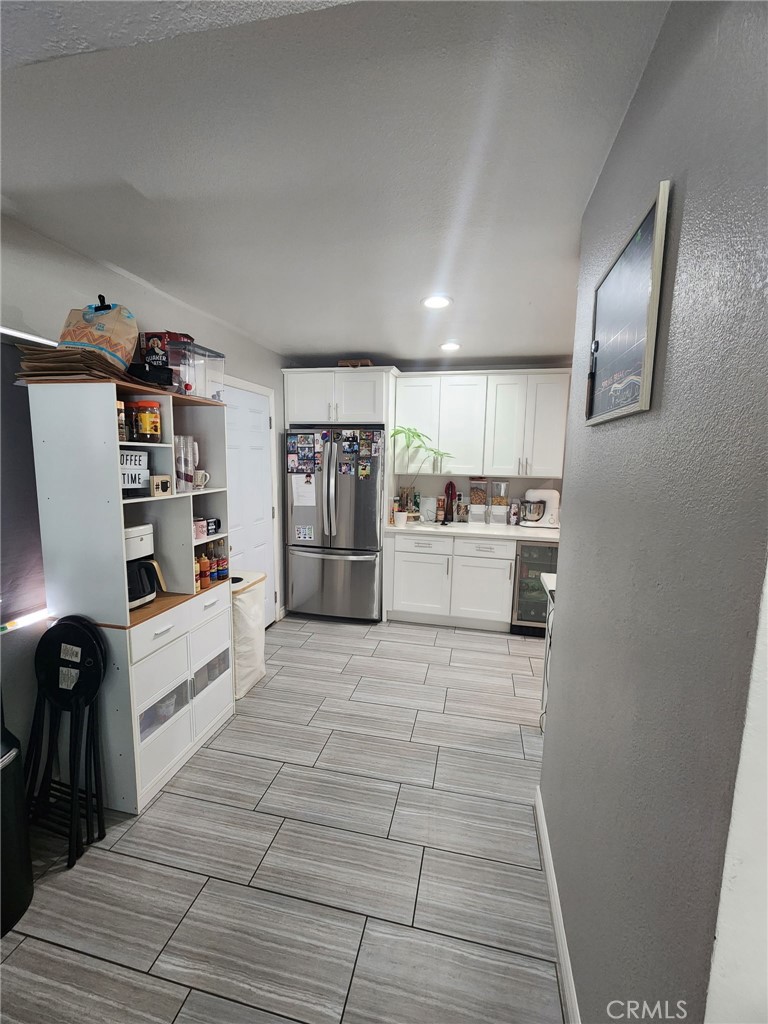3316 Joel Drive Riverside, CA 92509 - Photo 4 of 6 a large white kitchen with cabinets