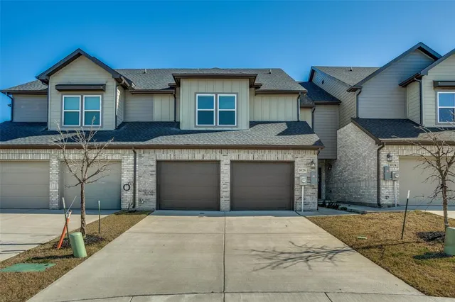 a front view of a house with garage