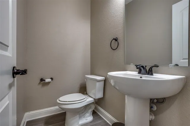 a bathroom with a sink toilet and a mirror