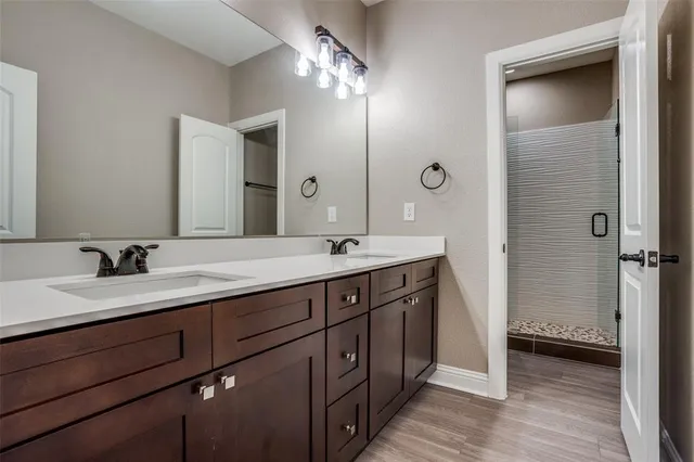 a bathroom with a double vanity sink and a mirror