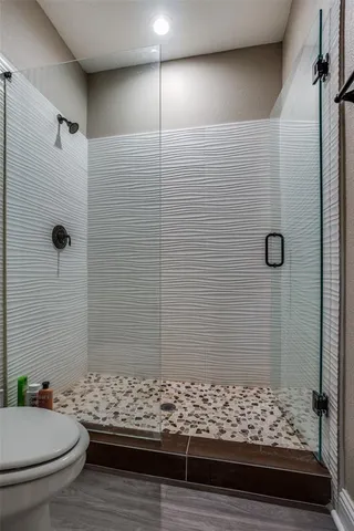 a bathroom with a granite countertop shower and a sink
