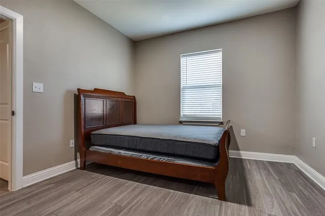 a room with wooden floor and window