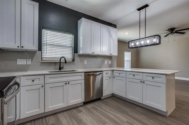 a kitchen with cabinets and window