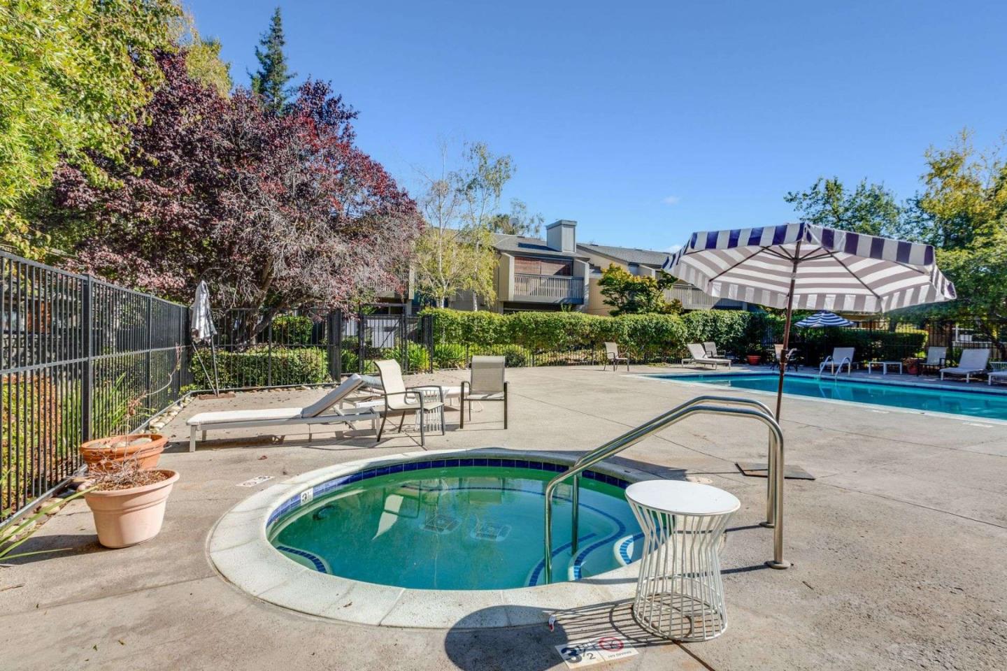 49 Showers Drive, Unit E152 Mountain View, CA 94040 - Photo 21 of 27 a swimming pool with outdoor seating and yard