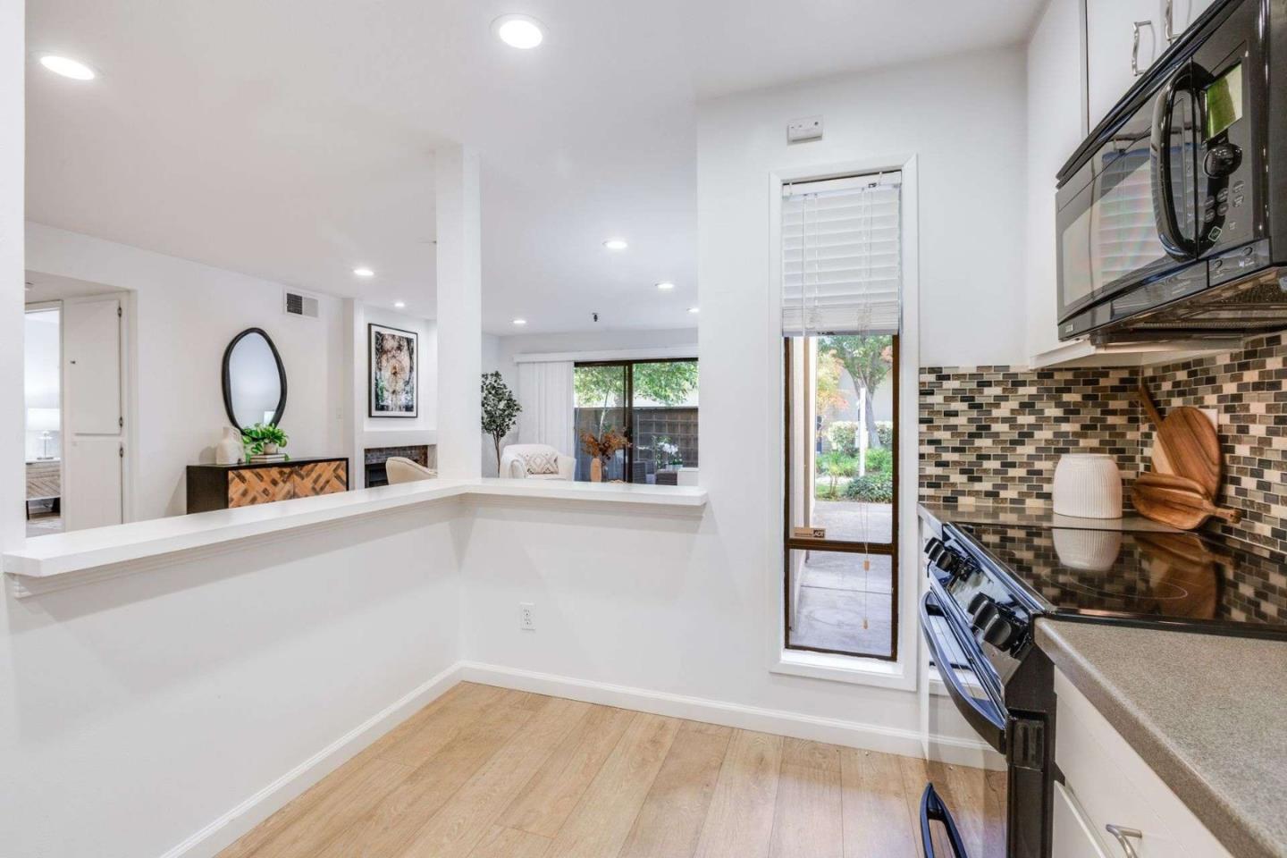 49 Showers Drive, Unit E152 Mountain View, CA 94040 - Photo 7 of 27 an open kitchen with granite countertop stove and sink