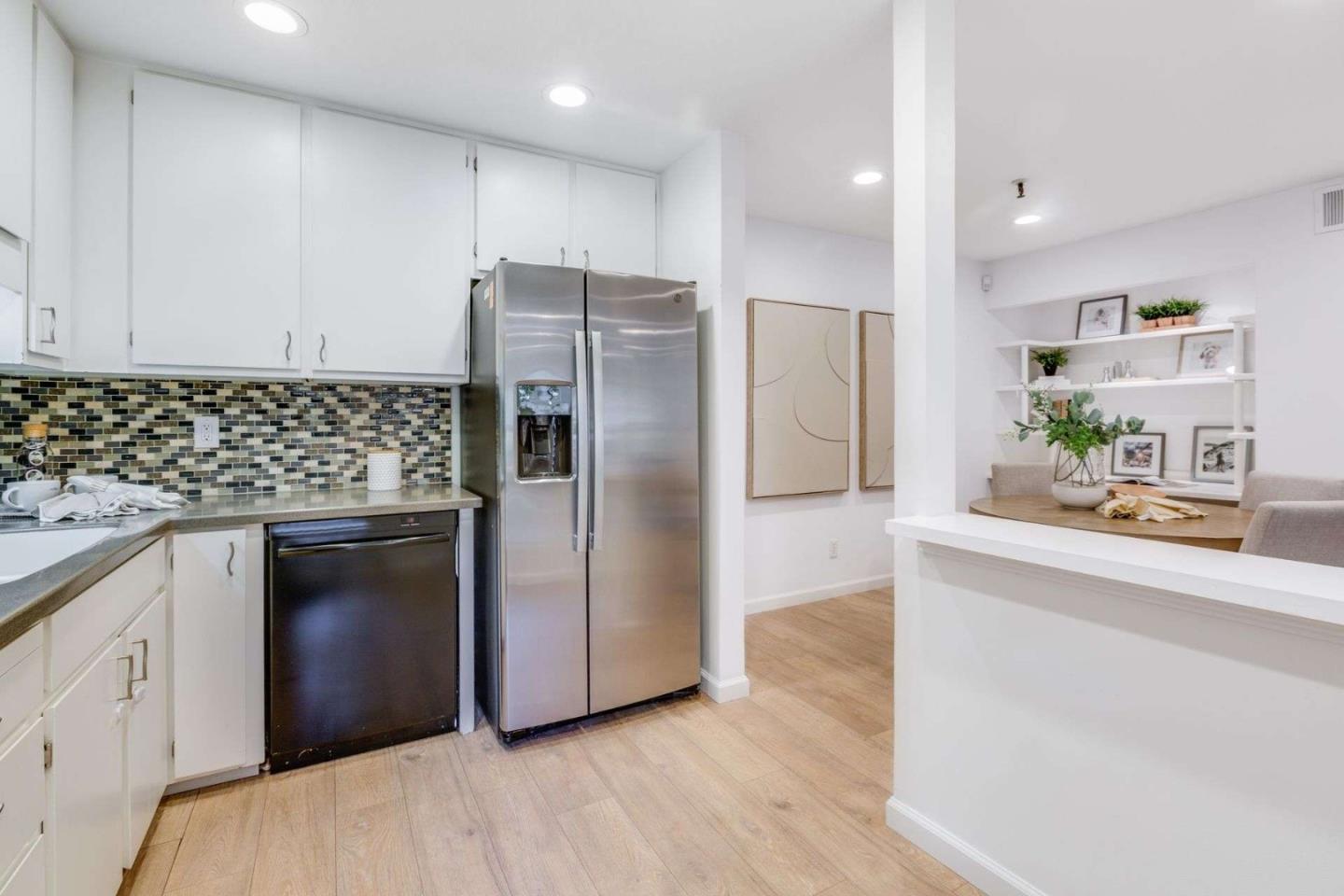 49 Showers Drive, Unit E152 Mountain View, CA 94040 - Photo 8 of 27 a kitchen with a refrigerator and a sink