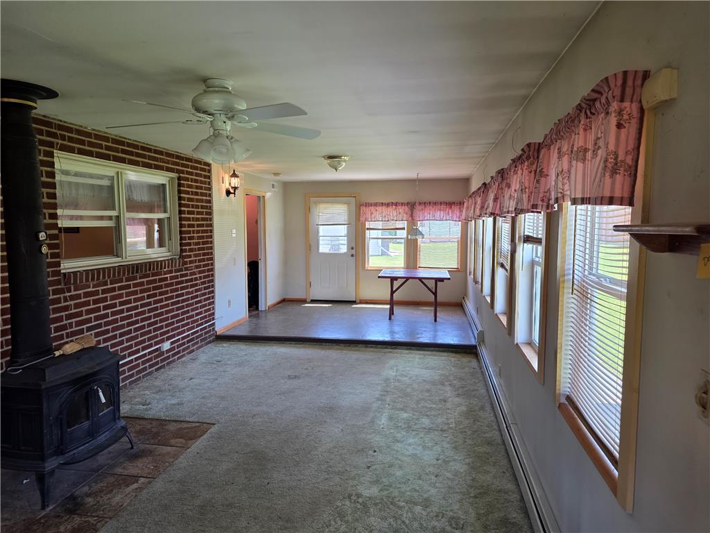 3134 Roxford Road Allentown, PA 18103 - Photo 23 of 34 A spacious sunroom offers abundant natural light and a charming wood-burning stove for cozy evenings.