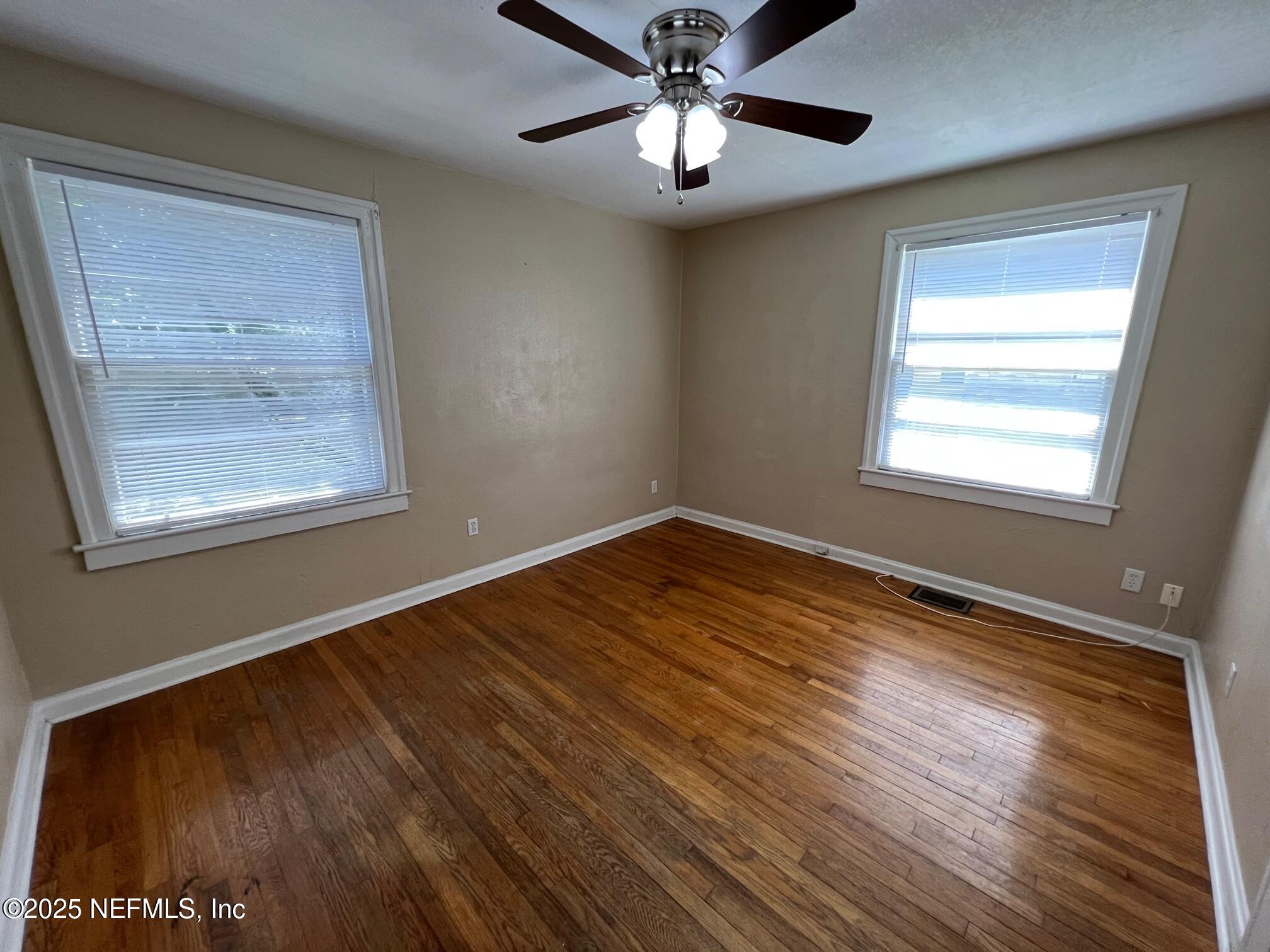 2614 College Street, Unit 1 Jacksonville, FL 32204 - Photo 12 of 17 a view of an empty room with wooden floor and a window