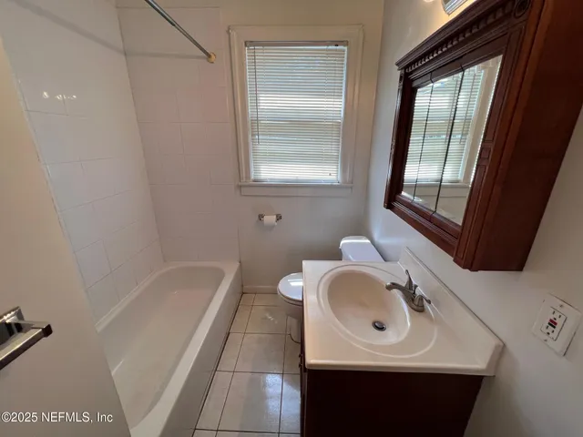a bathroom with a sink a toilet and tub