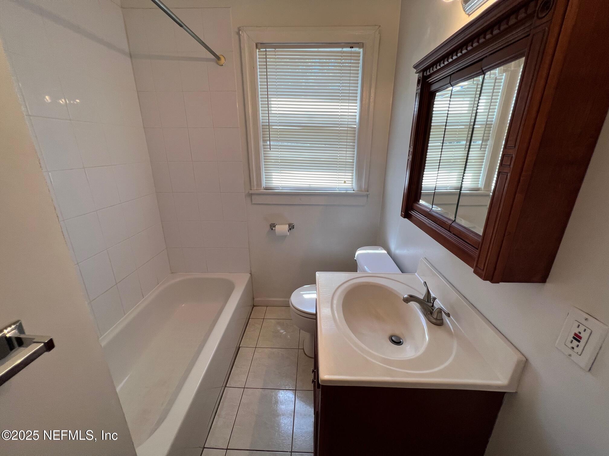 2614 College Street, Unit 1 Jacksonville, FL 32204 - Photo 16 of 17 a bathroom with a sink a toilet and tub