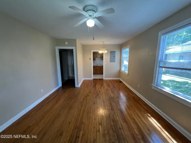 wooden floor in an empty room with a window