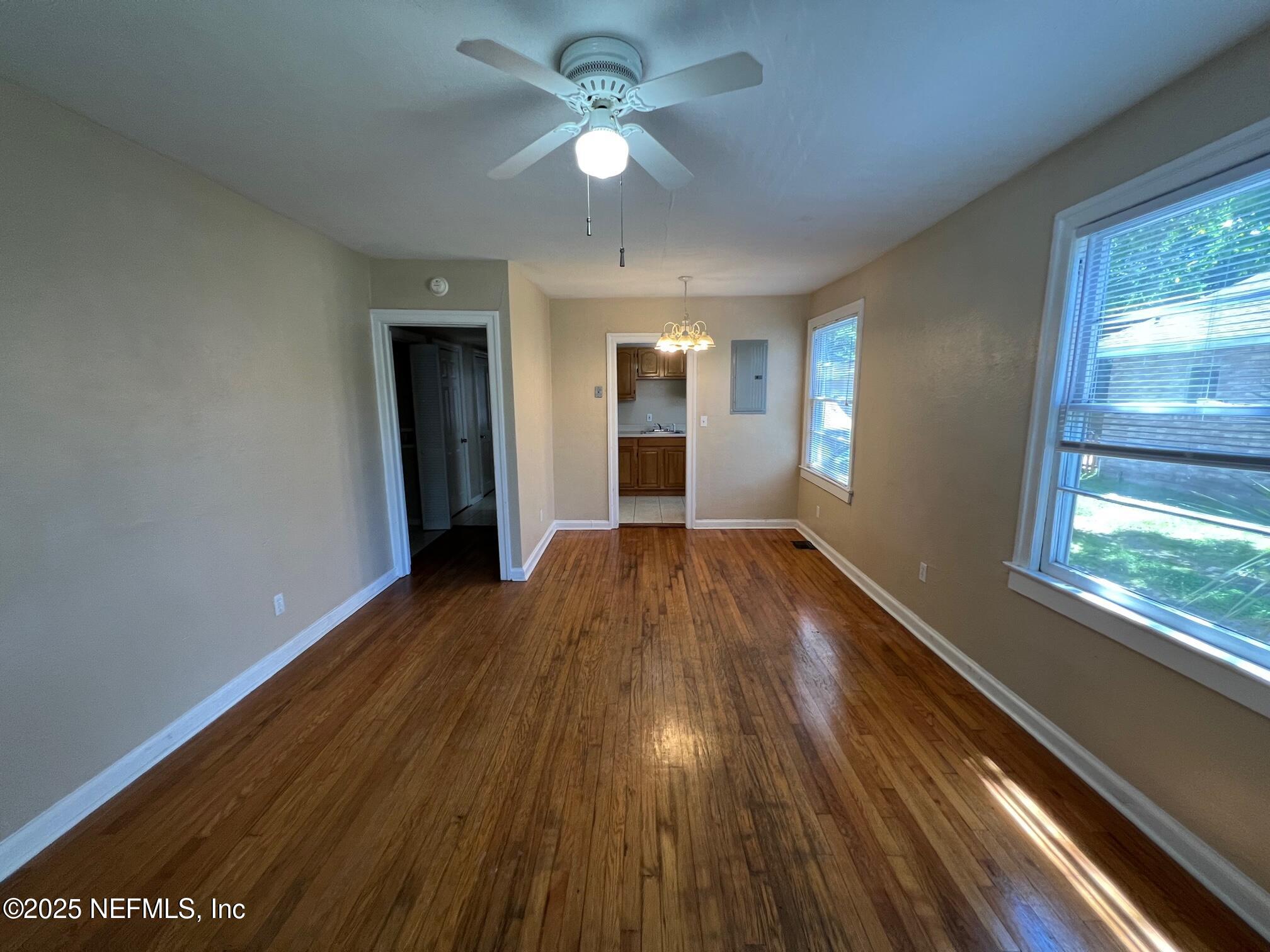 2614 College Street, Unit 1 Jacksonville, FL 32204 - Photo 3 of 17 wooden floor in an empty room with a window
