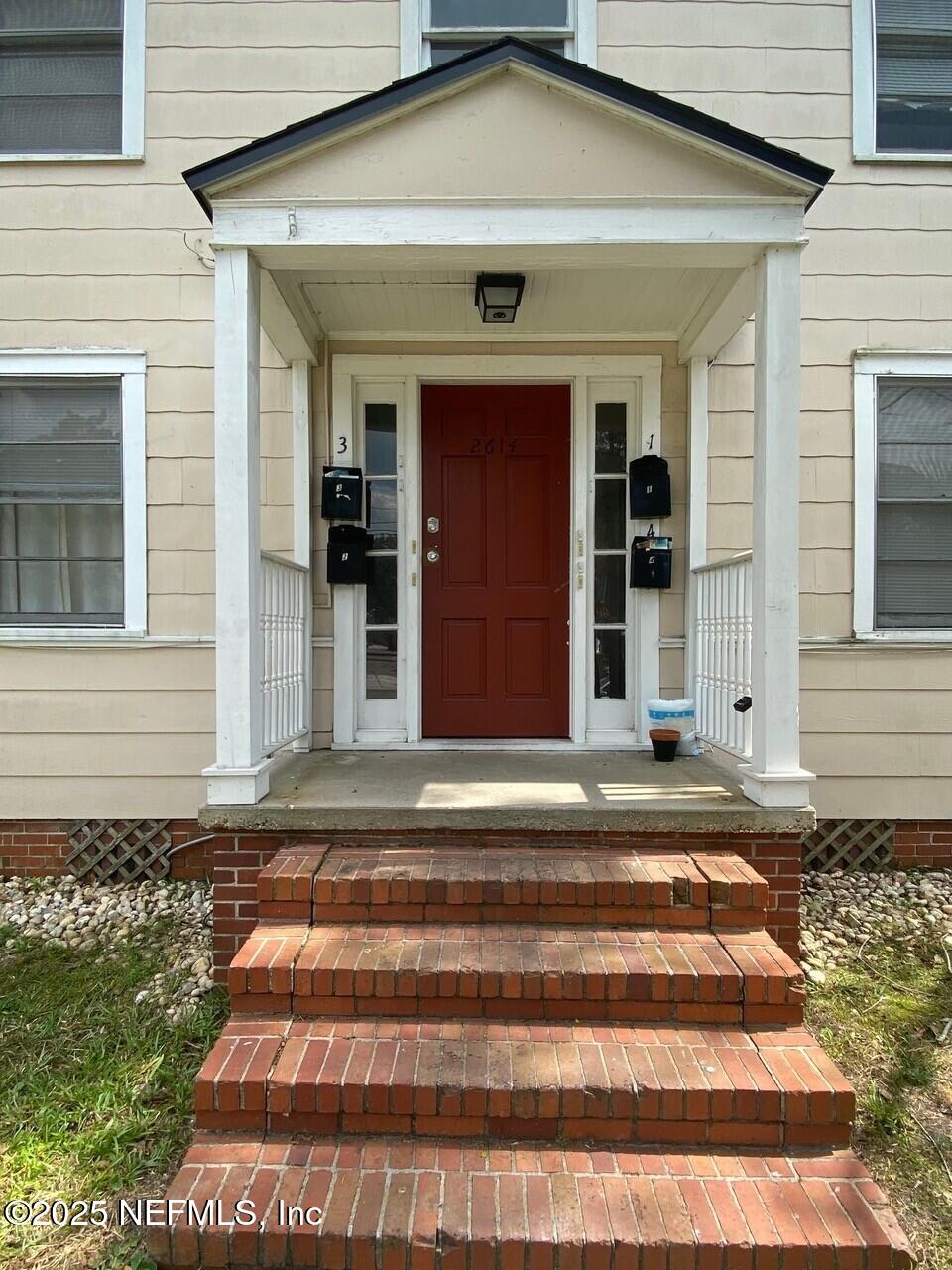 2614 College Street, Unit 1 Jacksonville, FL 32204 - Photo 4 of 17 a front view of a house with a yard
