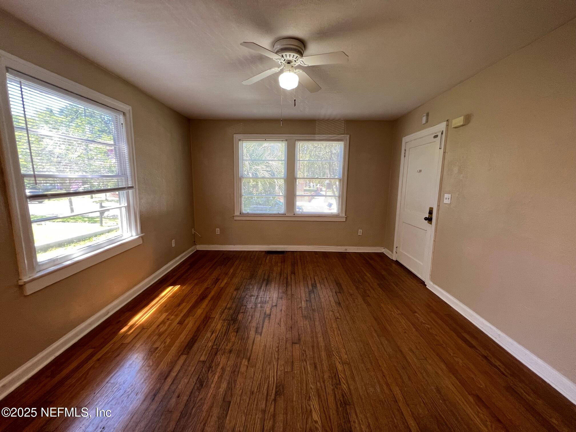 2614 College Street, Unit 1 Jacksonville, FL 32204 - Photo 5 of 17 a view of an empty room with wooden floor and a window