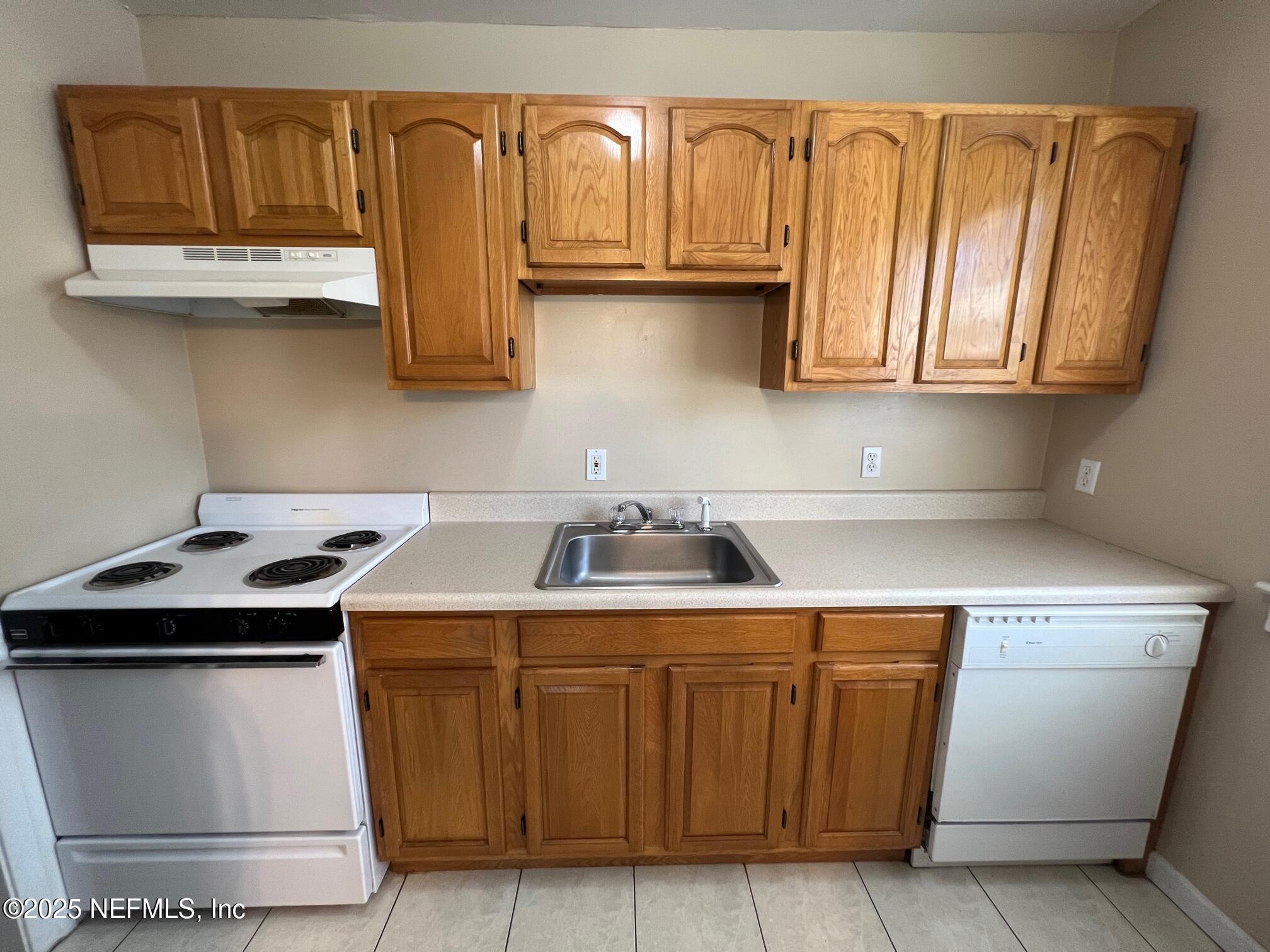 2614 College Street, Unit 1 Jacksonville, FL 32204 - Photo 9 of 17 a kitchen with stainless steel appliances granite countertop a sink and a stove