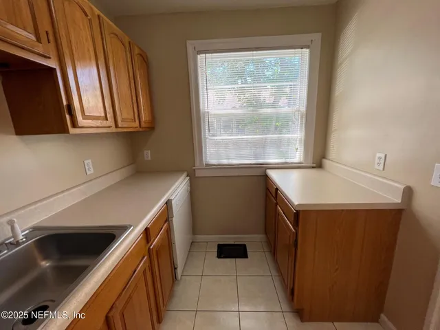 a kitchen with a sink and a stove top oven