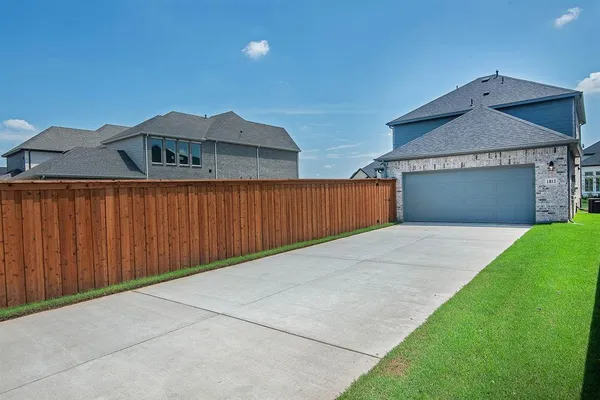 a view of a backyard with wooden fence