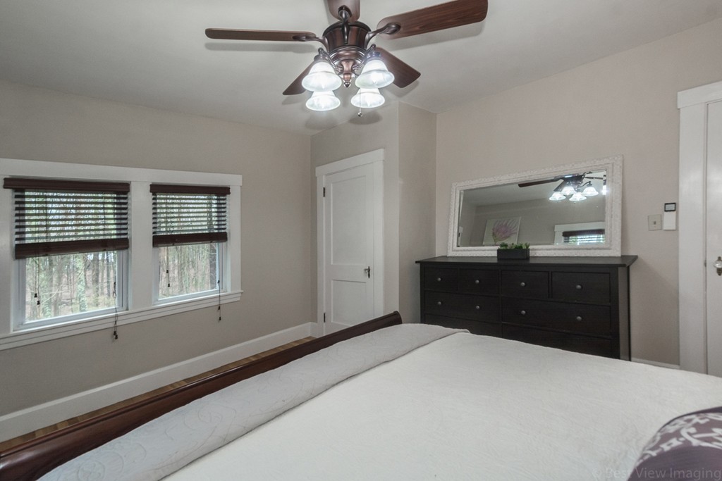 33 Burnham Road Bolton, MA 01740 - Photo 13 of 26 a bedroom with a large bed and a chandelier