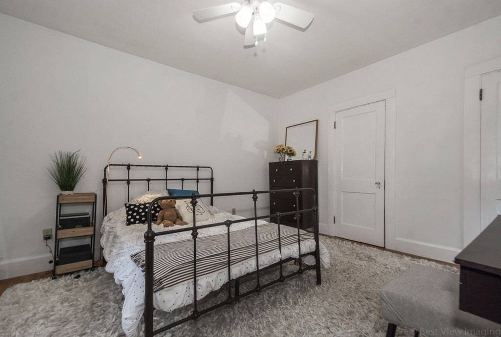 33 Burnham Road Bolton, MA 01740 - Photo 15 of 26 a bedroom with a bed and a chandelier