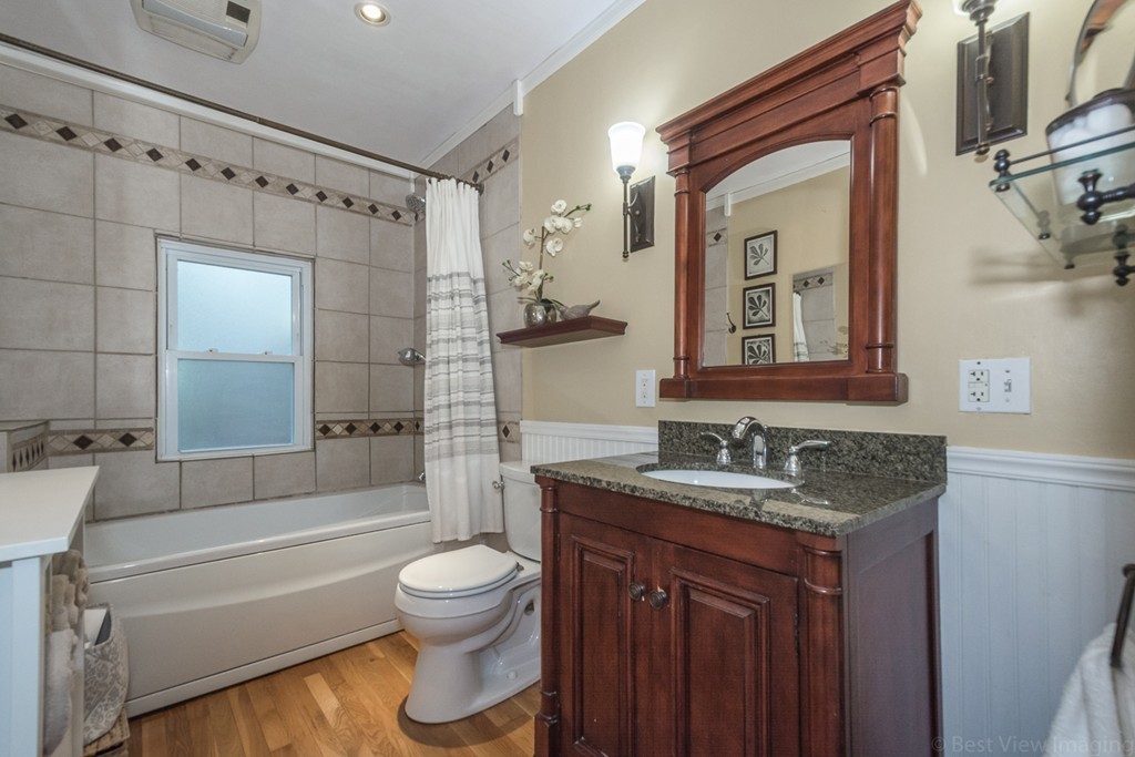 33 Burnham Road Bolton, MA 01740 - Photo 18 of 26 a bathroom with a granite countertop sink toilet mirror and bathtub