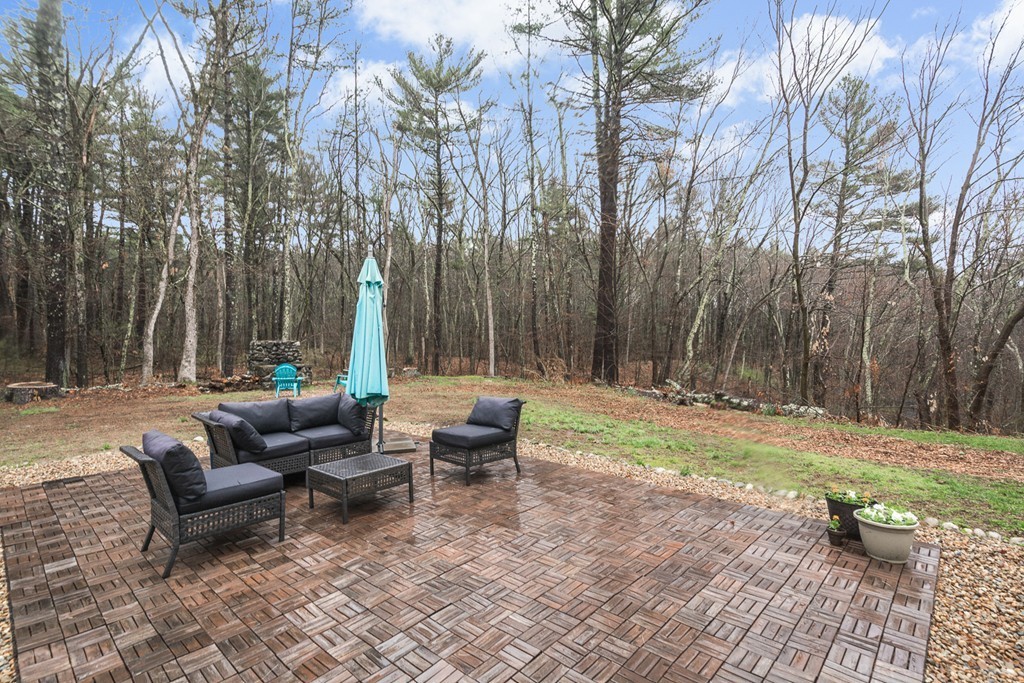 33 Burnham Road Bolton, MA 01740 - Photo 23 of 26 a backyard of a house with table and chairs