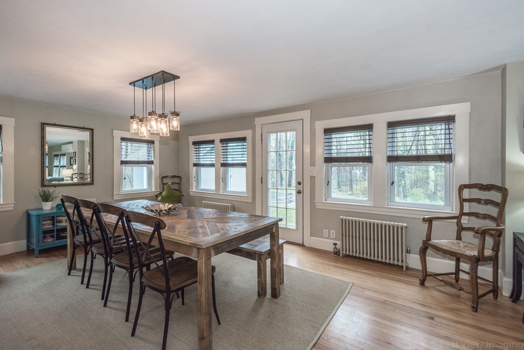 33 Burnham Road Bolton, MA 01740 - Photo 6 of 26 a view of a dining room with furniture a chandelier and wooden floor
