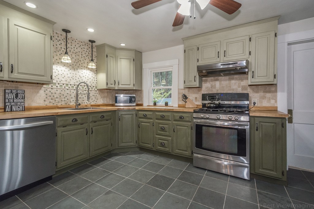 33 Burnham Road Bolton, MA 01740 - Photo 7 of 26 a kitchen with a sink cabinets and stainless steel appliances