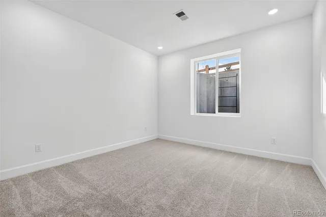an aerial view of a swimming pool with outdoor seating