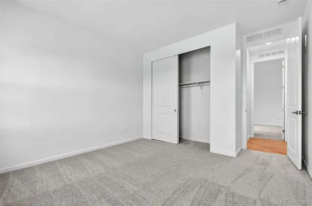 a view of hallway with wooden floor and fence
