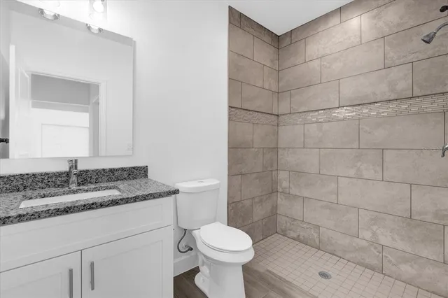 a bathroom with a sink toilet and shower