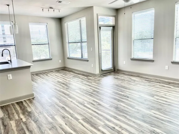 a kitchen with stainless steel appliances a refrigerator sink and cabinets