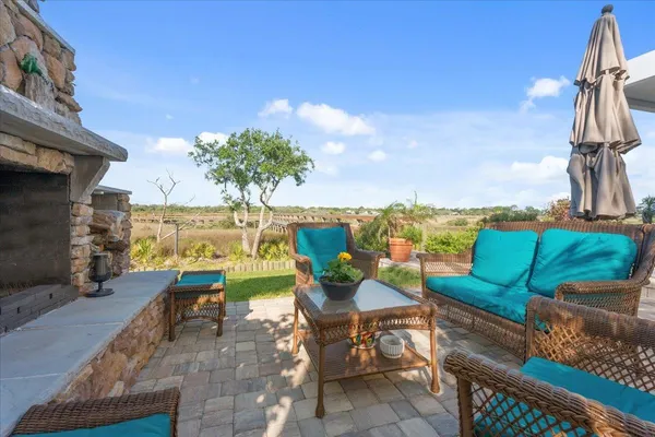 a view of a patio with couple of chairs and a potted plant