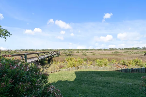 a view of a bench in the backyard of the house