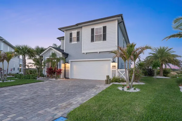 a dining room with furniture and a floor to ceiling window