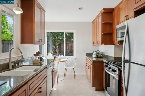 a kitchen with a sink stove and refrigerator