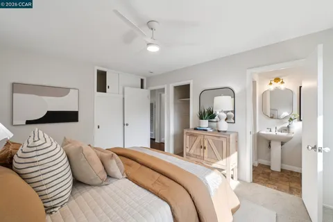 a bedroom with a large bed and a mirror