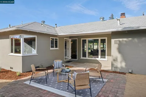 a view of a house with backyard porch and sitting area