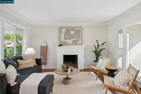 a living room with furniture fireplace and a large window