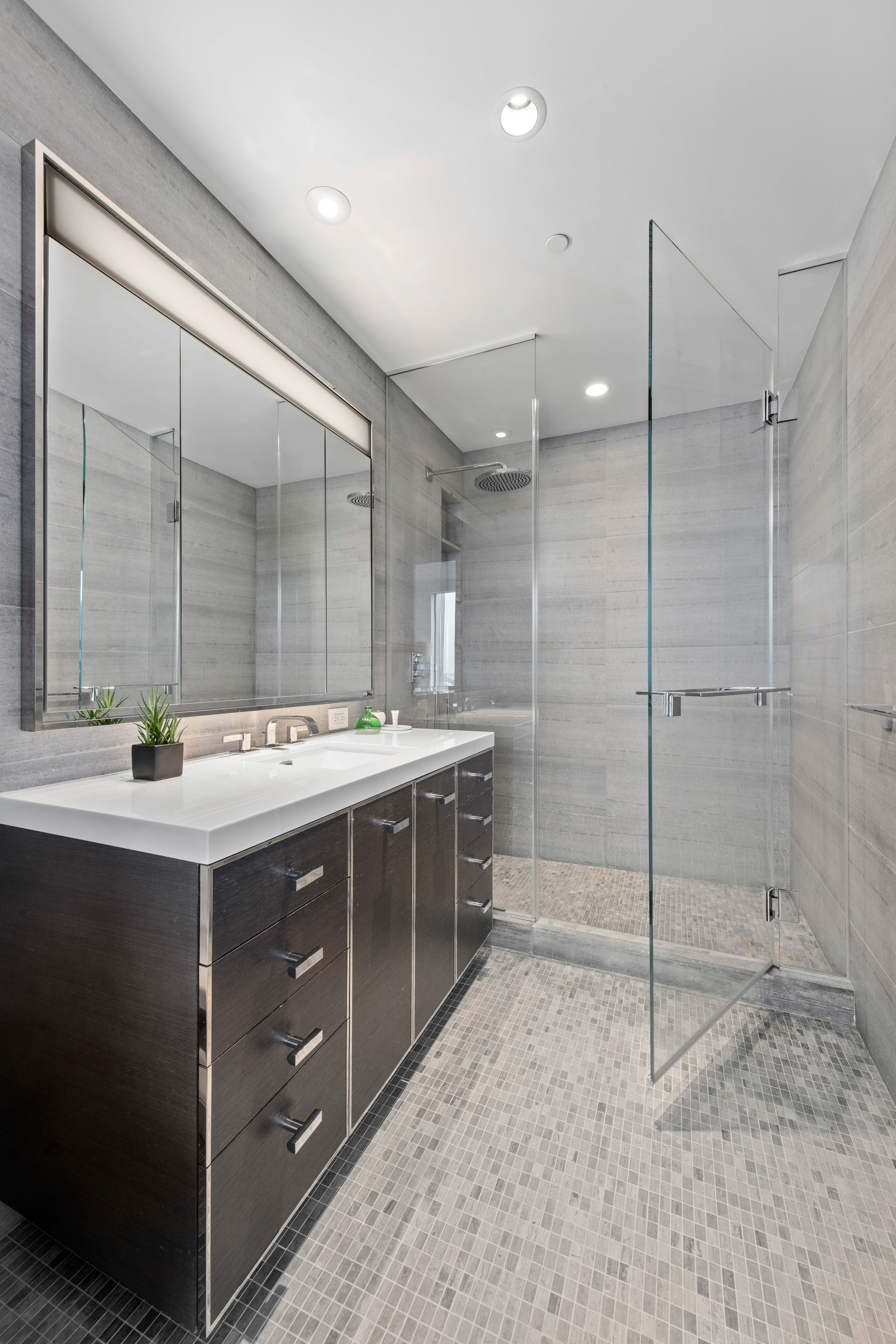 252 South Street, Unit 25D Manhattan, NY 10002 - Photo 11 of 36 a bathroom with a double vanity sink mirror and shower