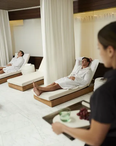 a view of a living room with furniture and floor to ceiling window