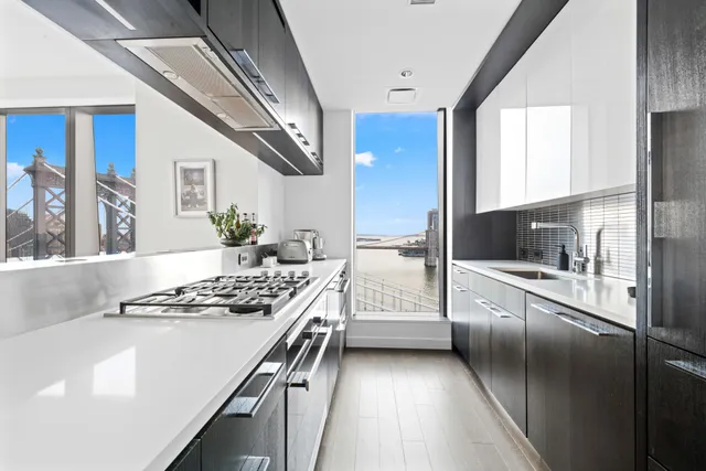 a open kitchen with stainless steel appliances kitchen island granite countertop a refrigerator and a stove