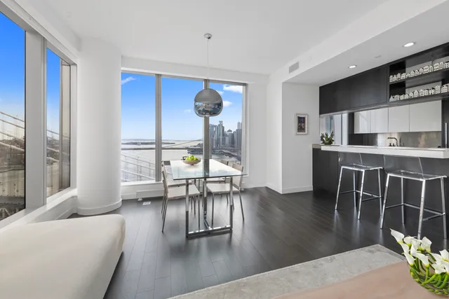a kitchen with kitchen island granite countertop a sink stove and refrigerator