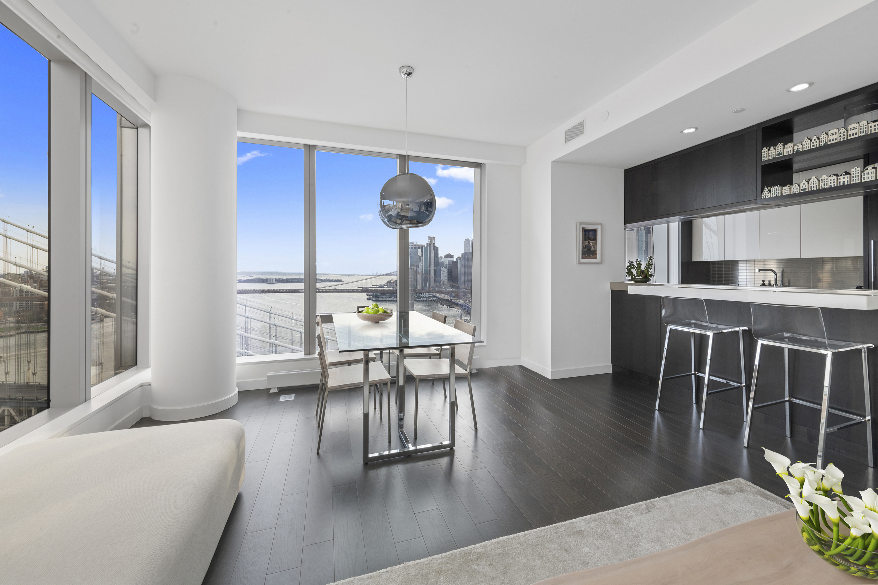252 South Street, Unit 25D Manhattan, NY 10002 - Photo 7 of 36 a living room with furniture a dining table and a fireplace