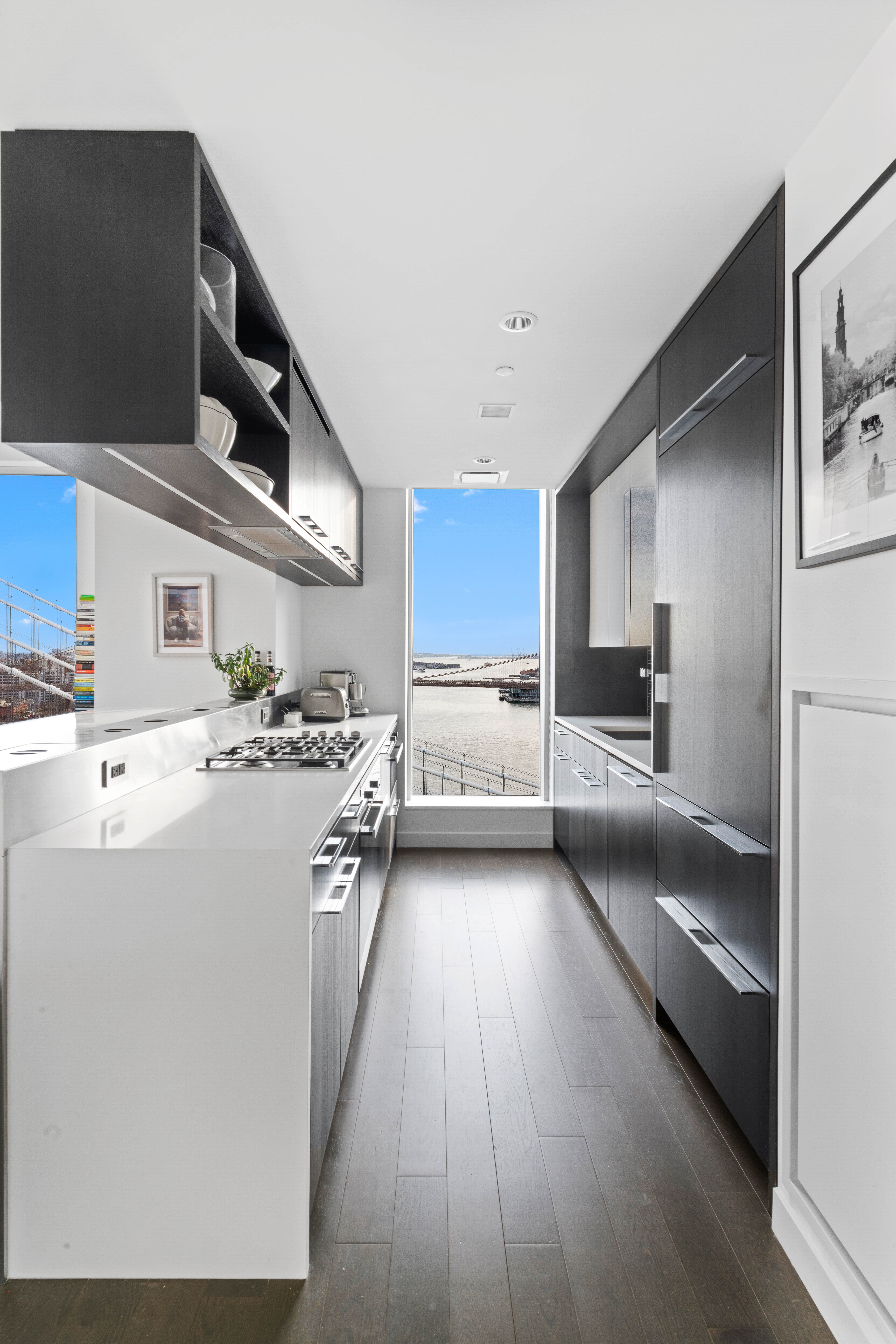 252 South Street, Unit 25D Manhattan, NY 10002 - Photo 8 of 36 a kitchen with stainless steel appliances a sink dishwasher stove refrigerator and cabinets