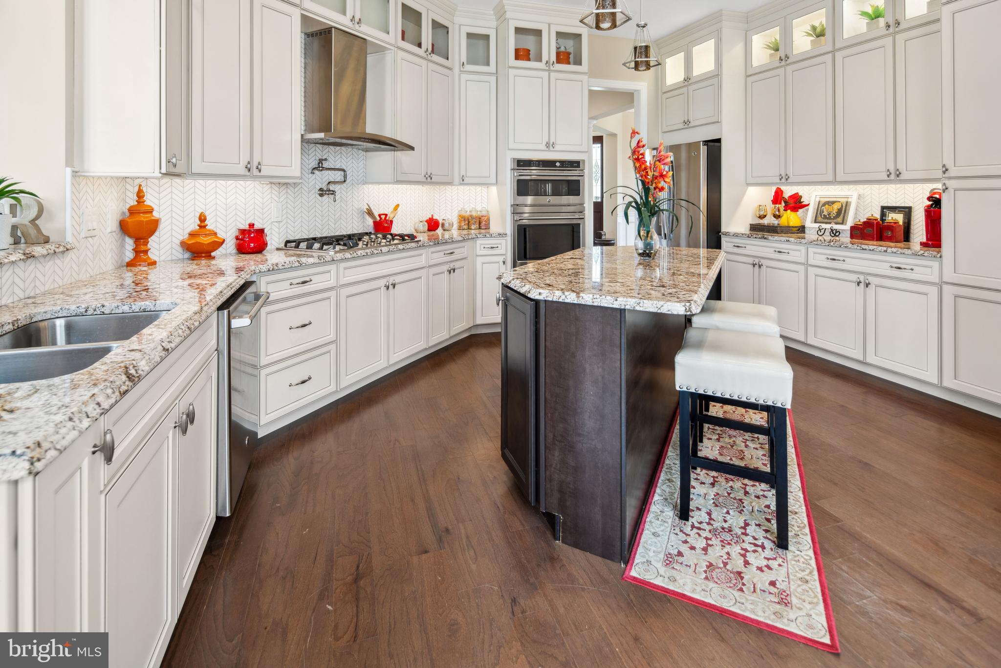 2 Samjan Circle Hightstown, NJ 08520 - Photo 4 of 36 a kitchen with stainless steel appliances kitchen island granite countertop a sink dishwasher and cabinets with wooden floor