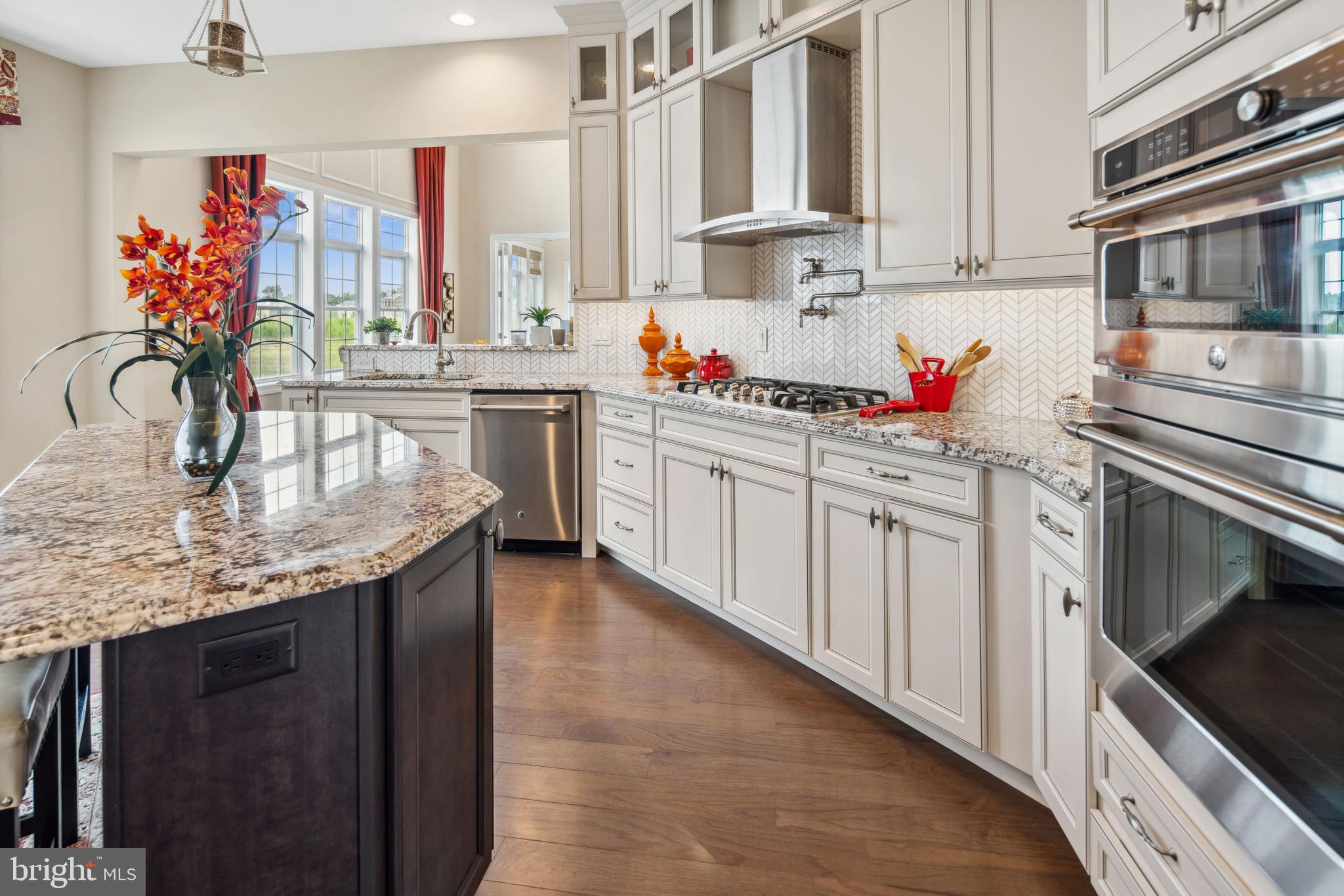 2 Samjan Circle Hightstown, NJ 08520 - Photo 6 of 36 a kitchen with stainless steel appliances granite countertop a sink dishwasher and cabinets with wooden floor